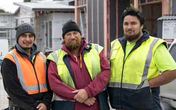 Three Māori workers in hi vis smiling